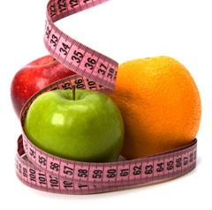 Apples and Orange surrounded by tape measure